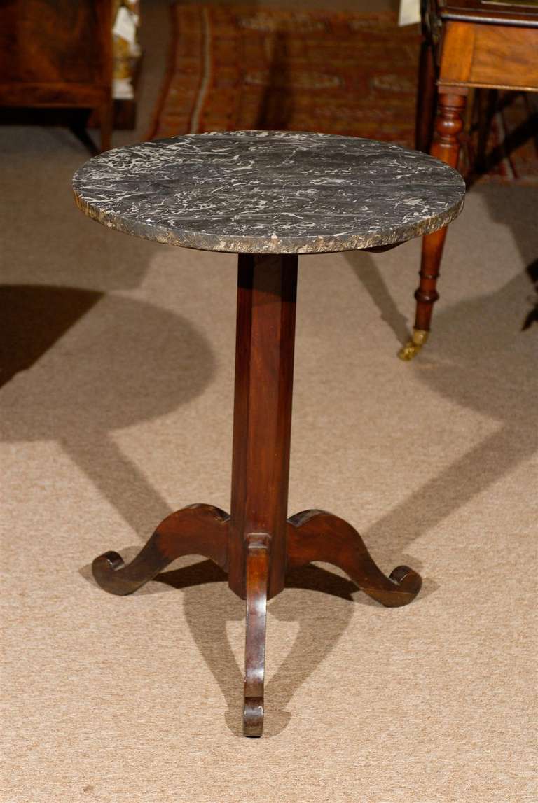 A mahogany gueridon table with tripod base and grey marble top. 
 
William word fine antiques: Atlanta's source for antique interiors since 1956.