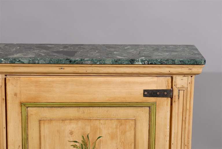A narrow pine 2 door cabinet with floral painting and green marble top. 

William Word Fine Antiques: Atlanta's source for antique interiors since 1956.