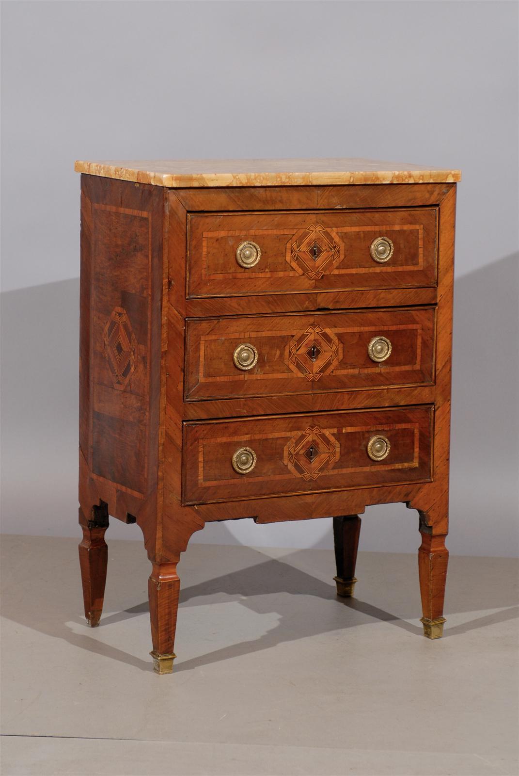 Neoclassical parquetry inlaid commodini with marble top and three drawers, carved apron, tapered legs with brass feet. 

William Word fine antiques: Atlanta's source for antique interiors since 1956.