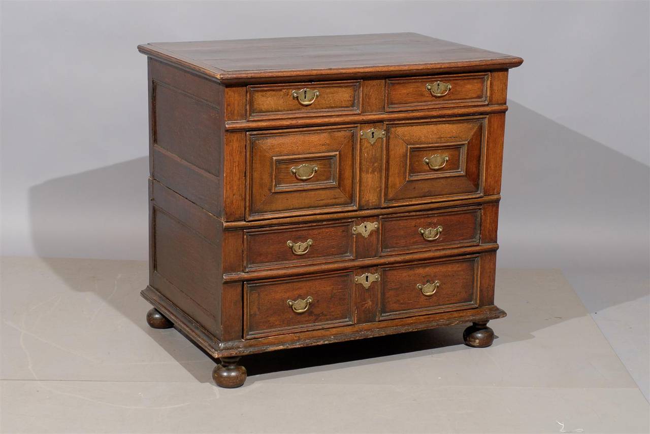 18th century English Jacobean style oak chest with 5 drawers and bun feet.