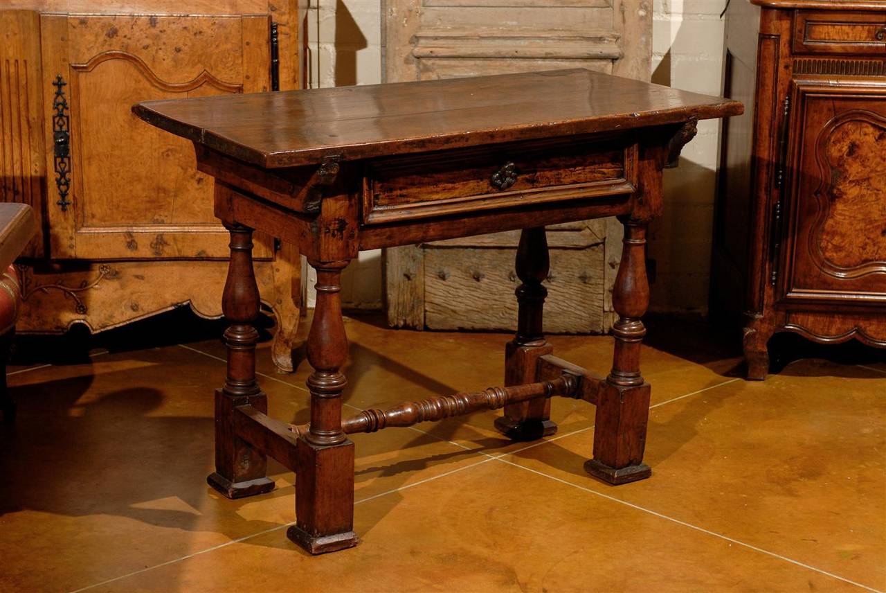 An early 18th century Italian walnut console table with drawer and stretcher.