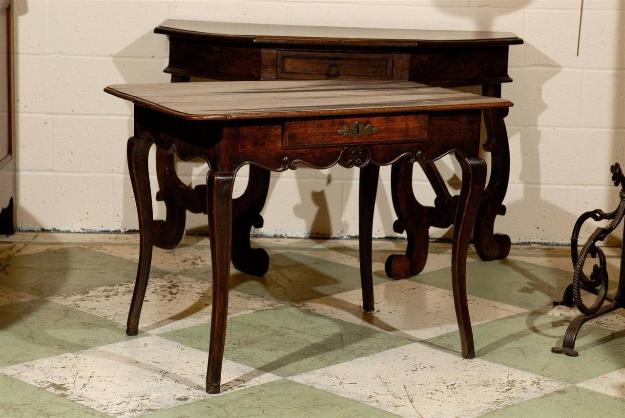 Louis XV oak and walnut side table with center drawer, shaped apron and hoofed feet. 

William Word Fine Antiques: Atlanta's source for antique interiors since 1956.