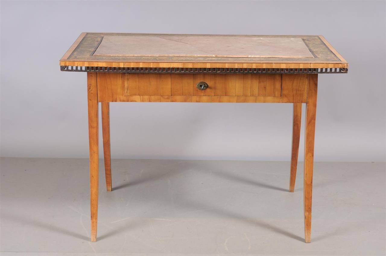 An unusual Austrian table with inset stone top, painted border, tapered splayed legs, and one (1) drawer. Finished on all sides, so can float in a room.

William Word Antiques, Atlanta's source for antique interiors since 1956.