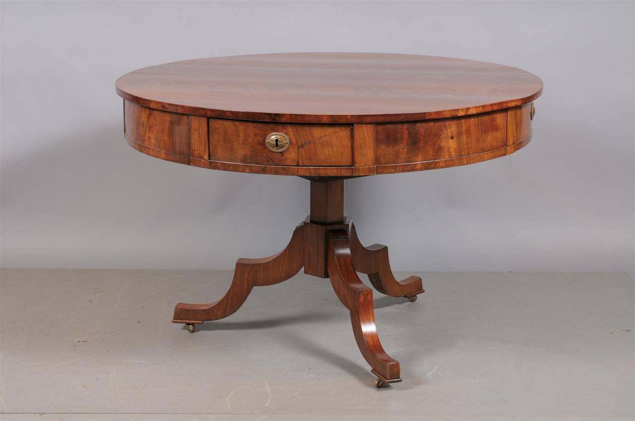 A Swedish center table in walnut with four sliding drawers and tripod base resting on castors. 

William Word fine antiques: Atlanta's source for antique interiors since 1956.