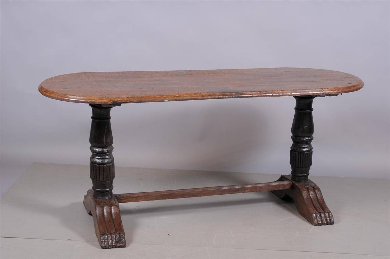 A Baroque style trestle oak table with oval top, carved turned legs and stretcher. 

William Word Fine Antiques: Atlanta's source for antique interiors since 1956.