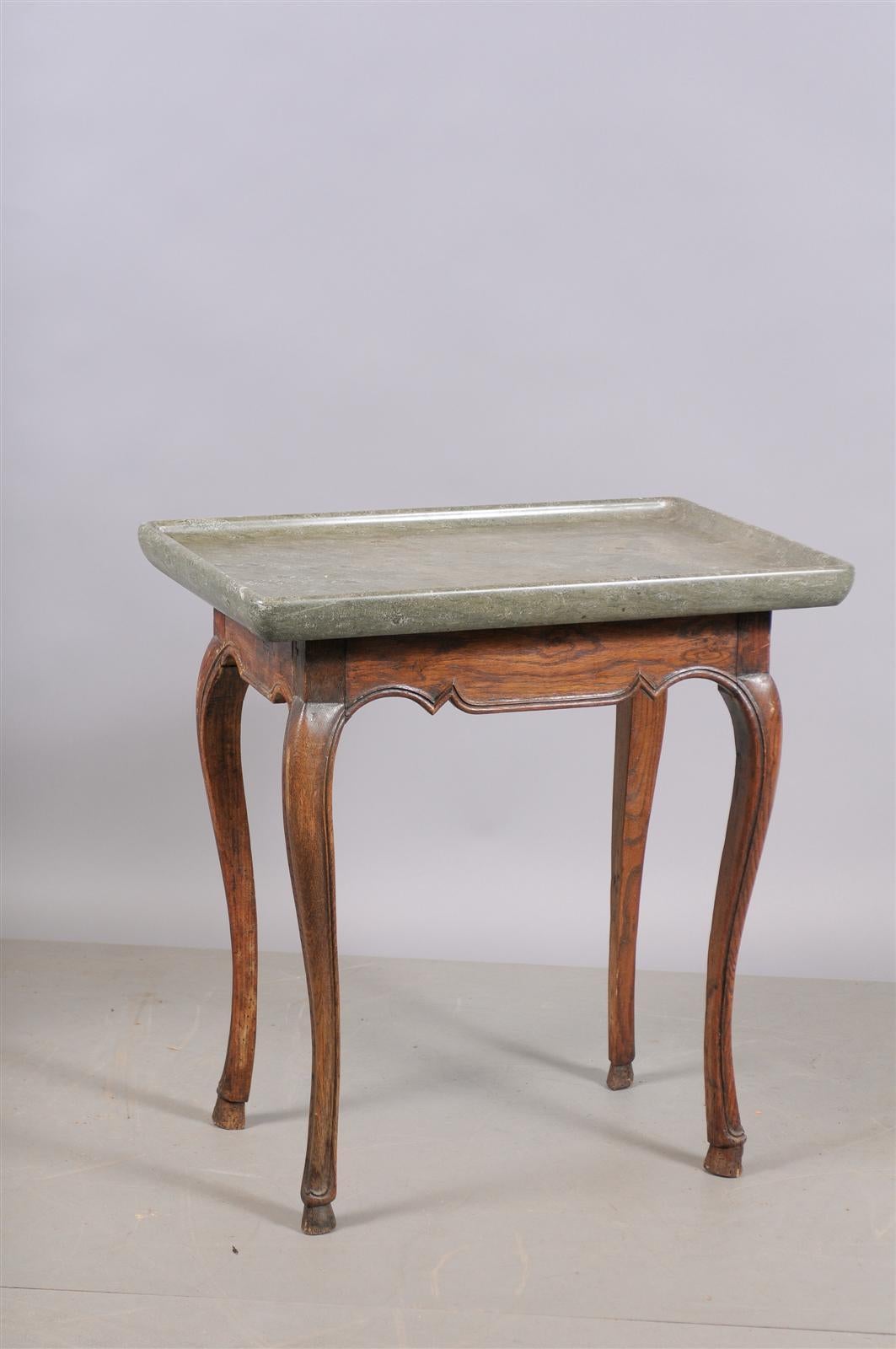 Swedish oak table with thick dish stone to, shaped apron and hoofed feet. 

William Word Fine Antiques: Atlanta's source for antique interiors since 1956.