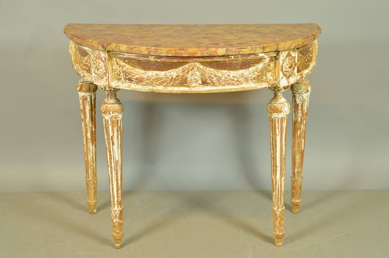 Louis XVI demilune console table with Breche d' Alep marble top, stripped gilt-wood finish, laurel swags on frieze and fluted carved legs. 

William Word Fine Antiques: Atlanta's source for antique interiors since 1956.