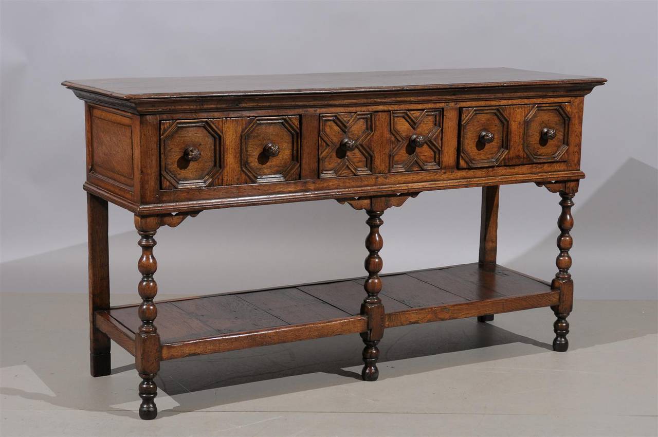 19th century English Jacobean style oak dresser base / server with lower shelf, wood knobs and lower shelf.

To view our entire inventory, please visit our personal website.

William Word Fine Antiques: Atlanta's source for antique interiors