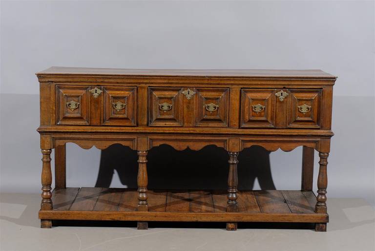 19th century English oak Jacobean style dresser base with lower shelf and three drawers.

William word fine antiques: Atlanta's source for antique interiors since 1956.
