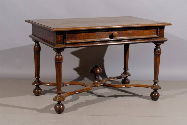 A large French Louis XIII style oak side table with shaped cross stretcher and drawer.