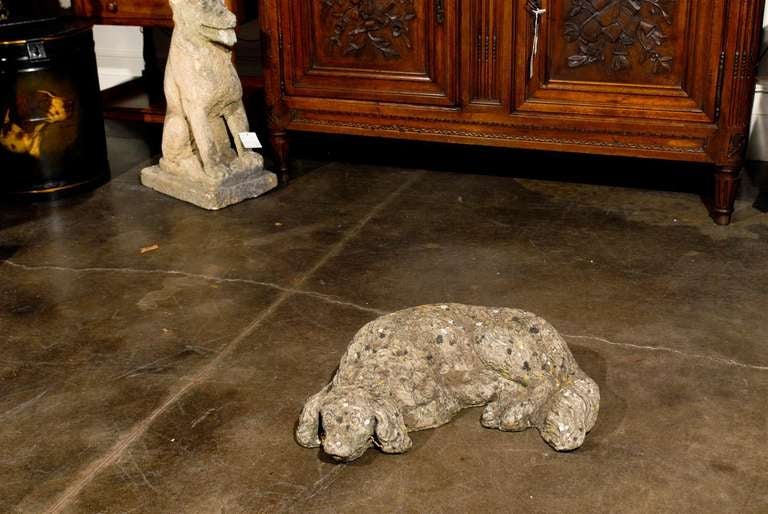 Carved French Reclining Cast Stone Dog with Weathered Appearance from the 1930s