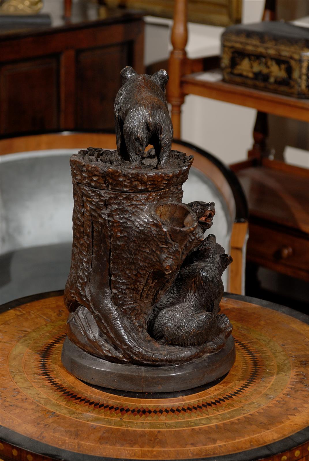 An early 20th century wooden carved bear humidor from Switzerland. This wooden carved Swiss humidor from the early 20th century features three bears climbing on a trunk. One of them stands on top while the others are around the trunk. Humidors are