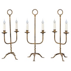 Three Gilt Iron Spanish Two-Arm Candelabra on Tripod Bases with Vegetal Décor