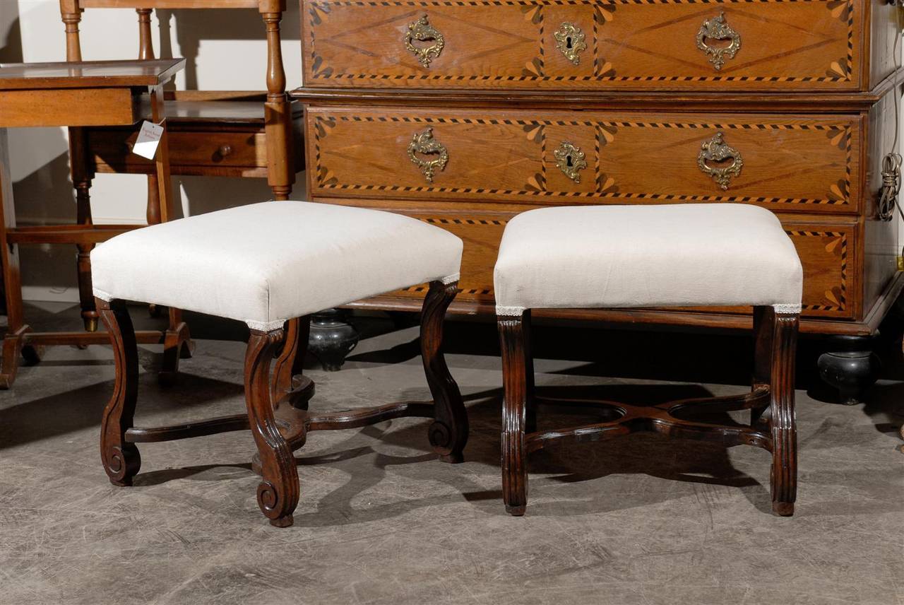Pair of French upholstered stools with stretcher.