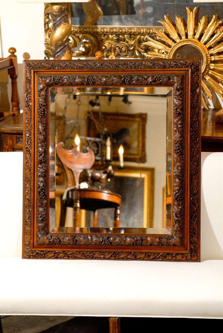 Carved English 1880s Rectangular Mirror with Bevelled Glass and Foliage Adorned Frame