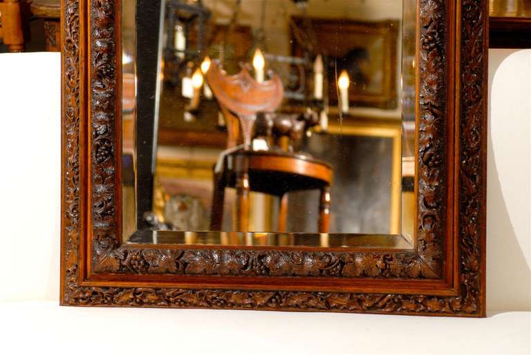 English 1880s Rectangular Mirror with Bevelled Glass and Foliage Adorned Frame 1