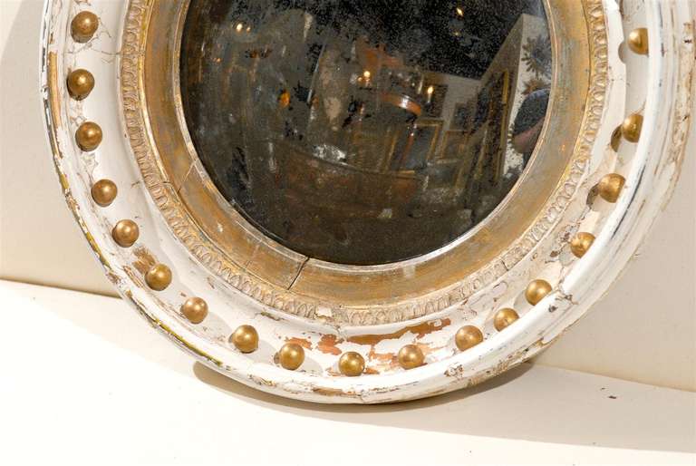 English round distressed convex bullseye mirror.