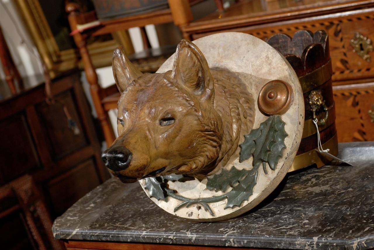 Painted iron fox head on round iron back.