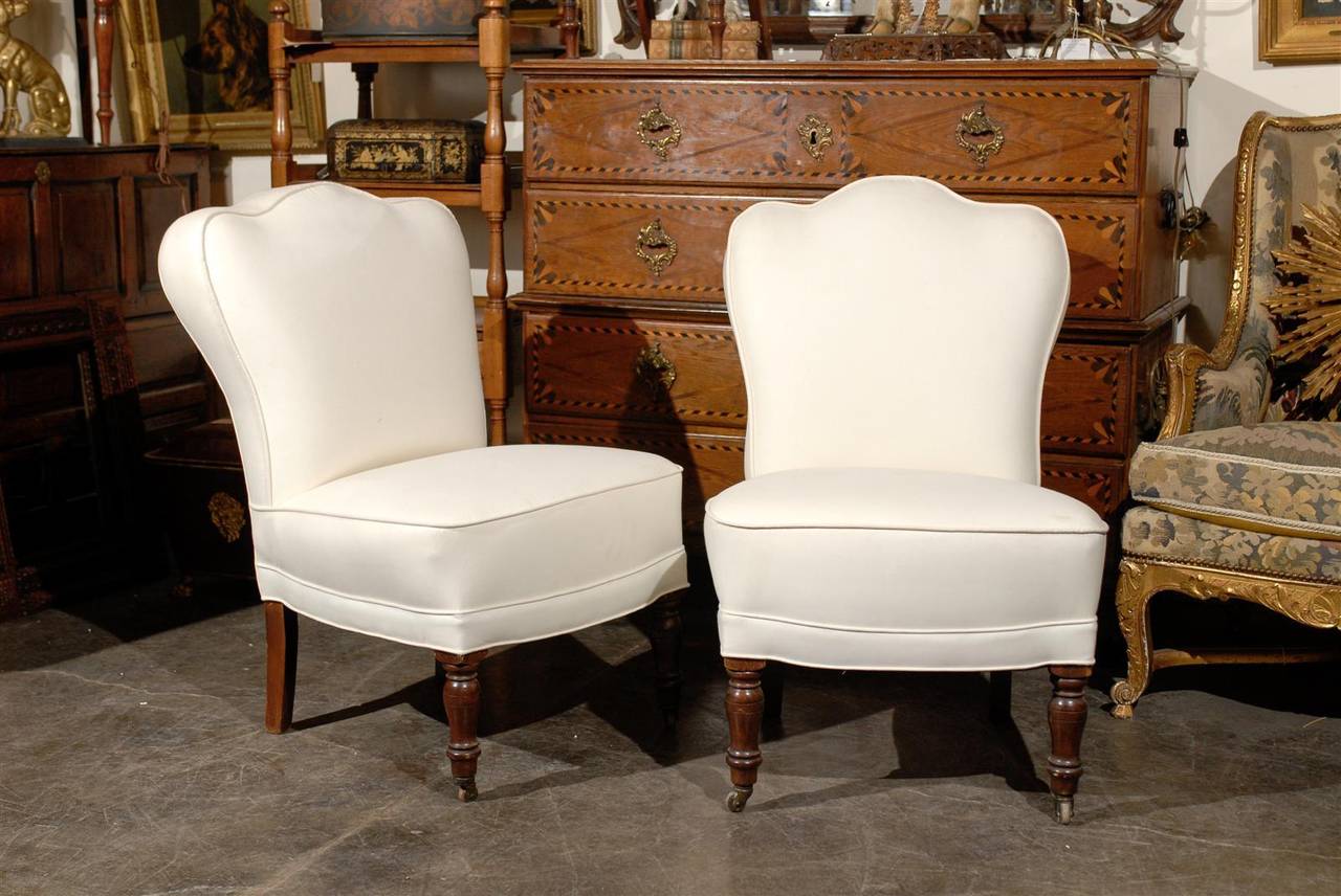 Pair of English slipper chairs with scalloped backs.