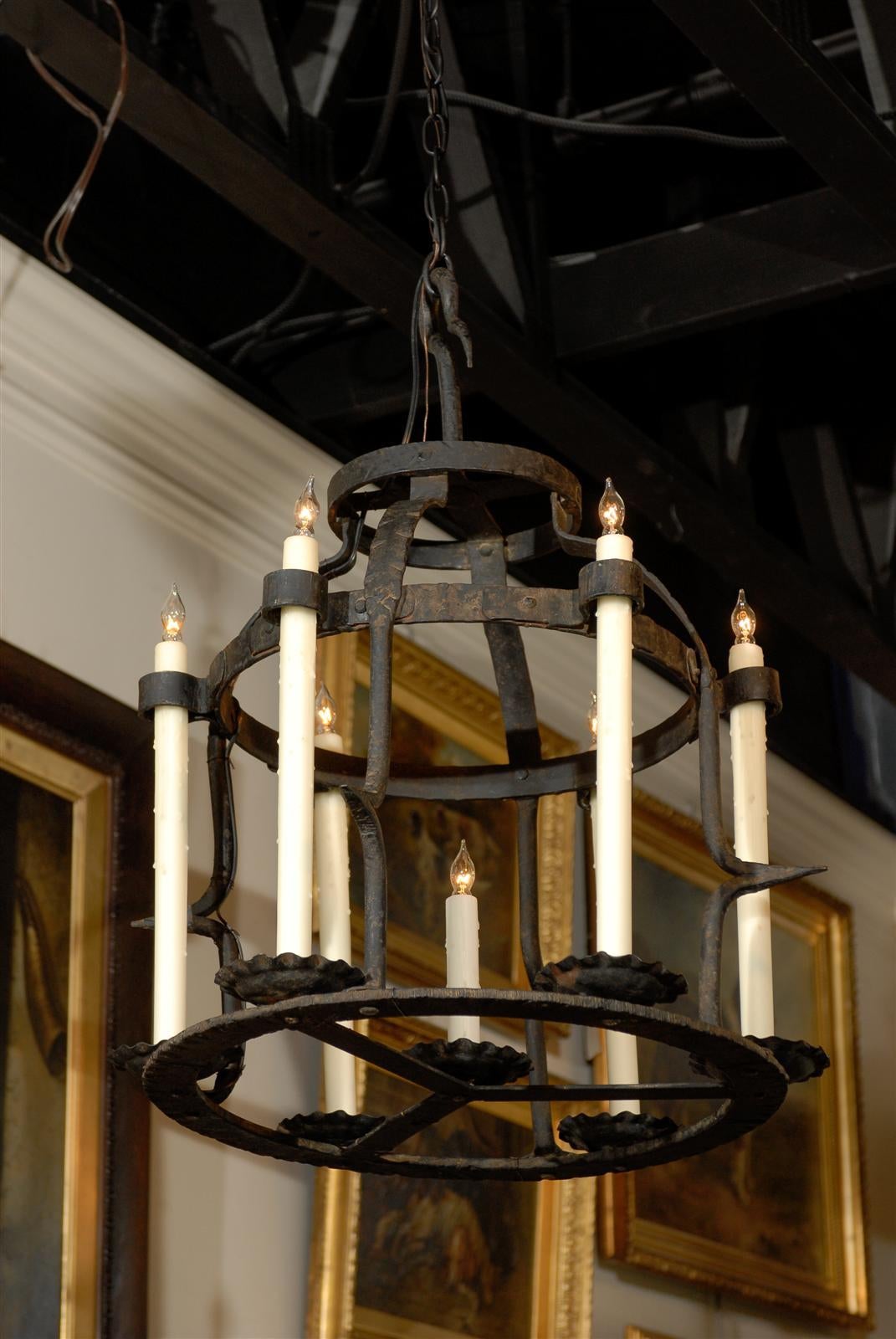 French iron chandelier with new wiring and wax candle sleeves.