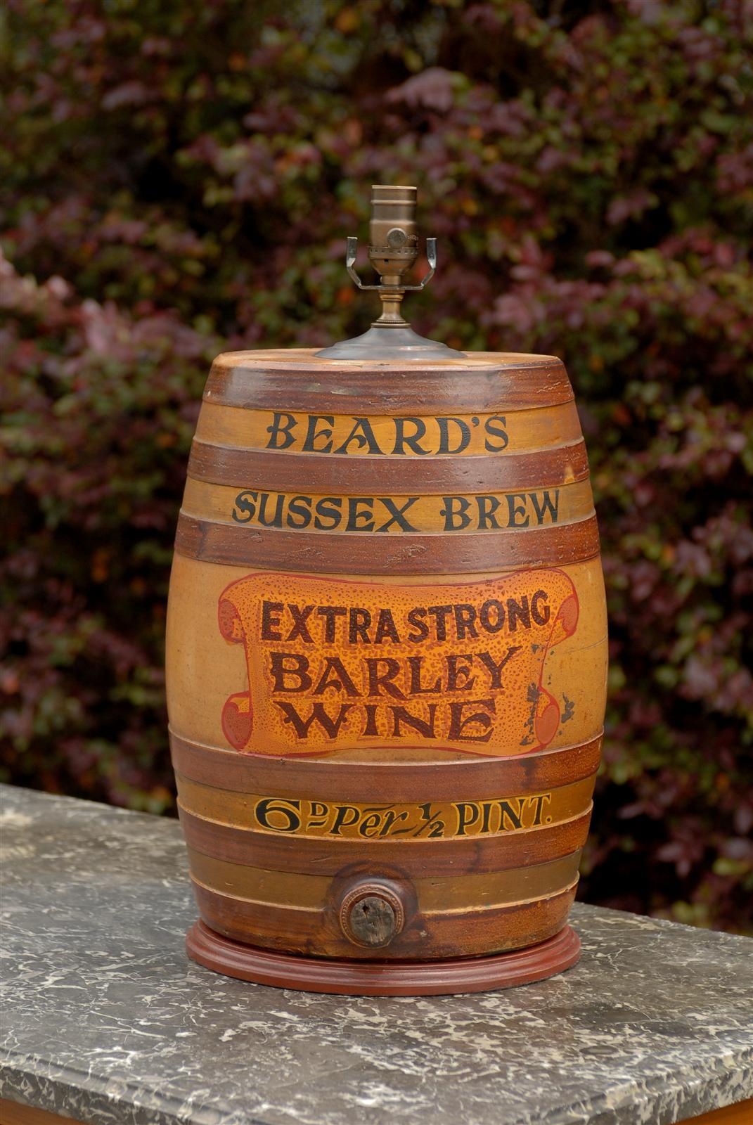 This large stoneware spirit barrel from the late 19th century has been transformed into a beautiful table lamp. The lamp is made of a lighter brown circled by six faux darker brown straps. The barrel features the name Beard’s Sussex Brew. The