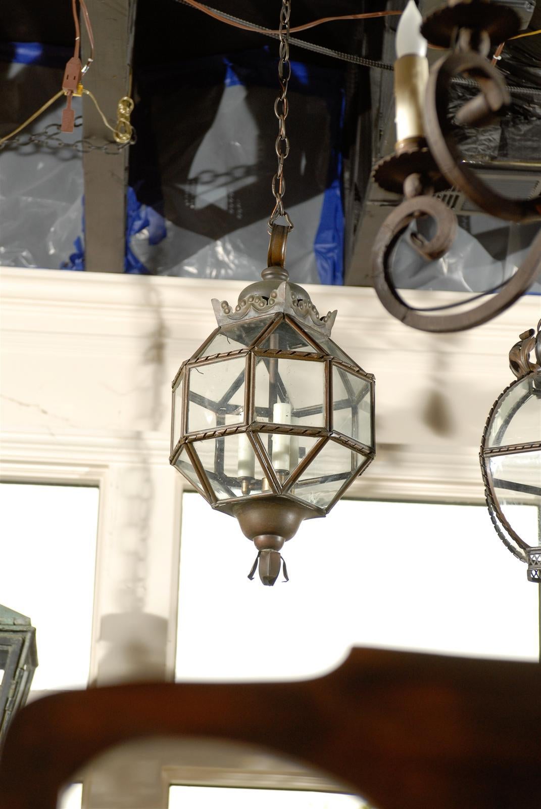 An Italian lantern made of metal and glass with a sphere shape from the mid 20th century.  This Italian glass and metal lantern features a polygonal sphere with a metal structure with a ribbon decor surrounding glass squares, with new wiring and wax