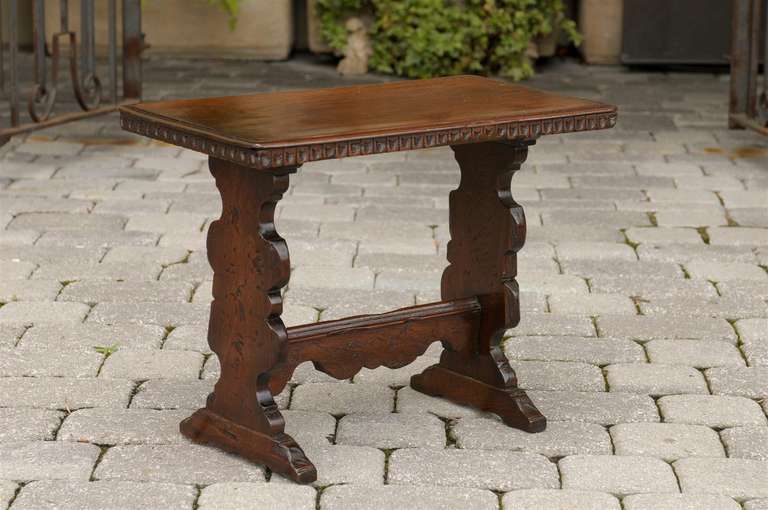 Italian low table or bench with stretcher and carved edges.