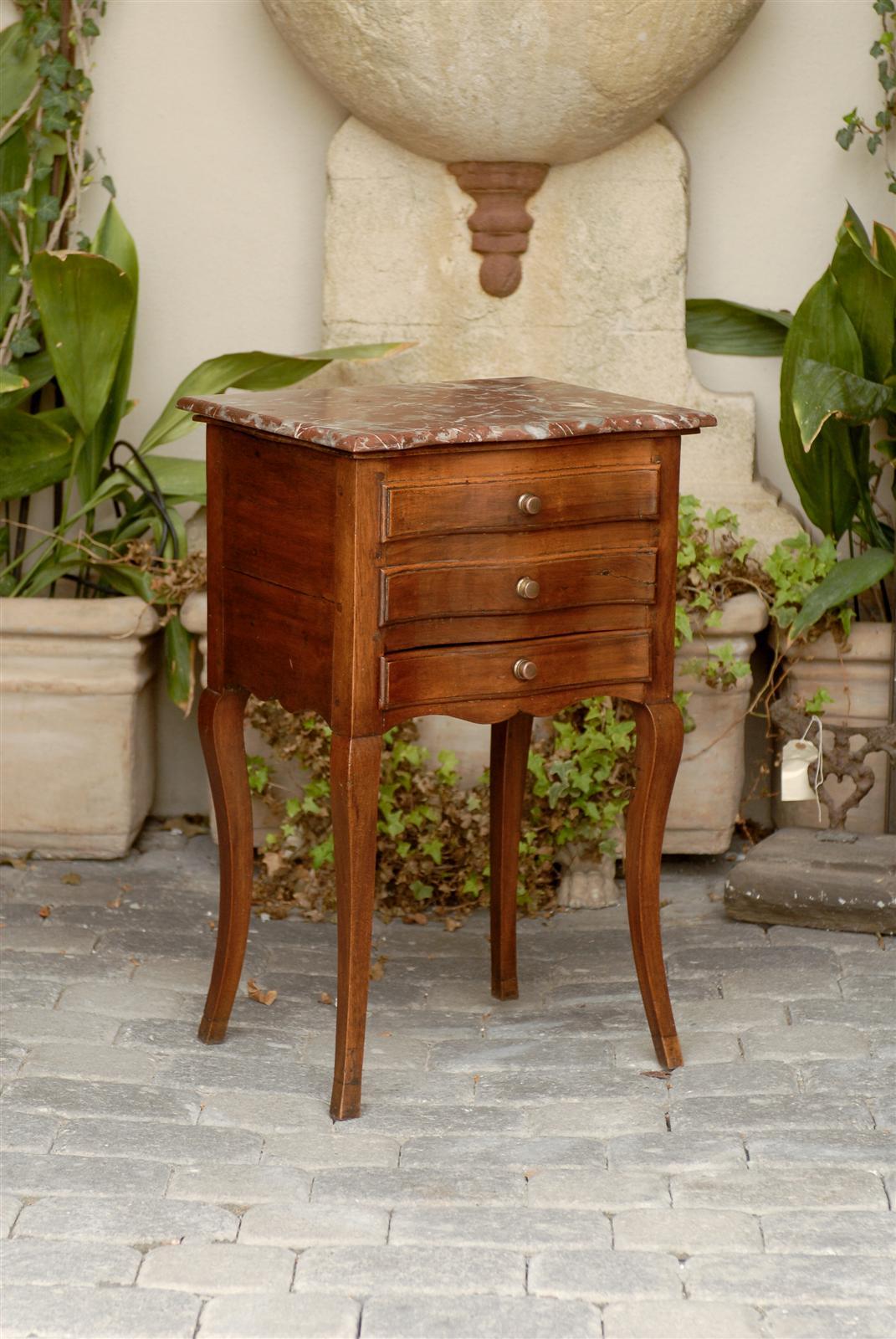 A French serpentine front marble top commode from the late 19th century. This petite commode is a charming object of levity. It features a front made of three drawers, two of which are faux and a hidden back that opens via a door to reveal a zinc