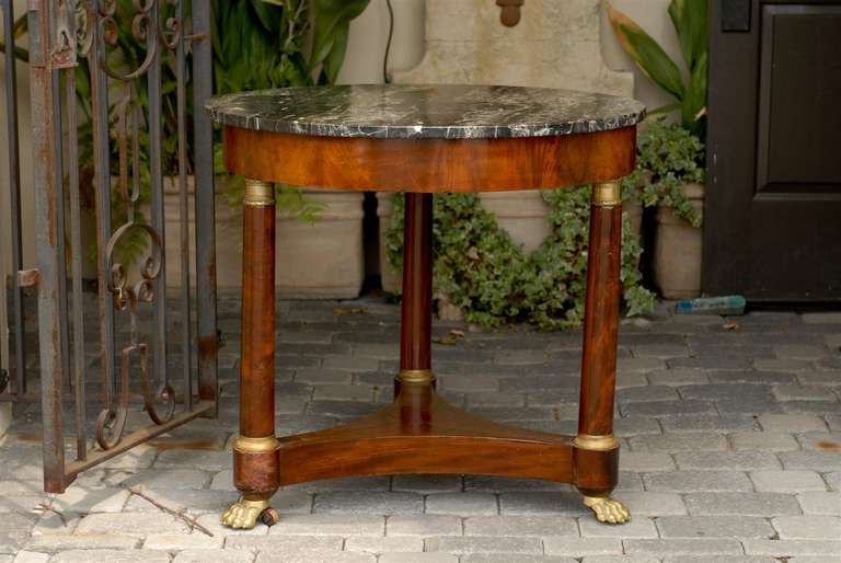 French round marble top table with claw feet.