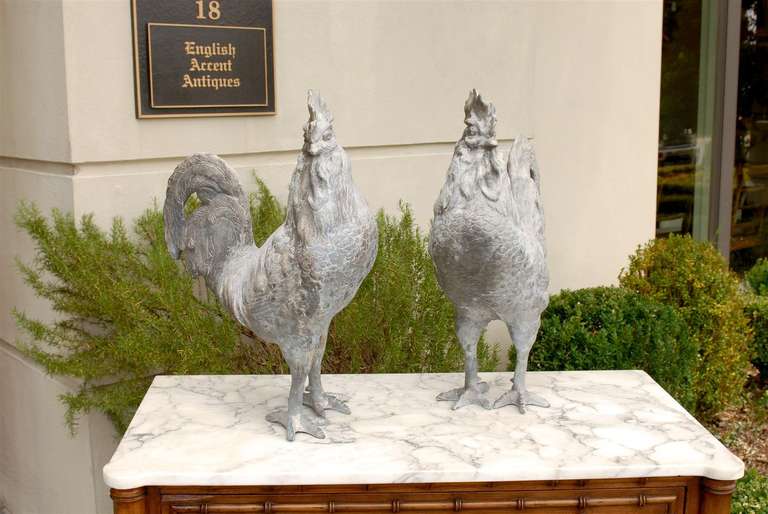 Life size pair of lead roosters.