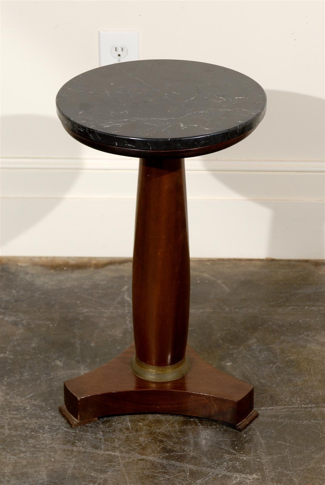 Round French Empire pedestal table with marble top.