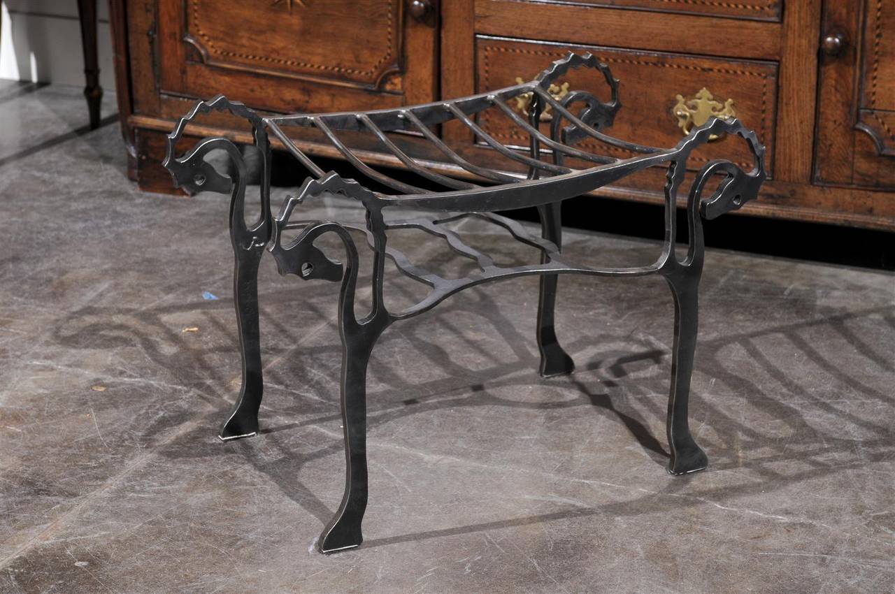 This small size steel bench from the mid-20th century features a very unique Silhouette. The steel seat is slightly curved to provide more comfort. The eye is immediately drawn to the whimsical legs, made of seahorses. Below the seat is a shelf that