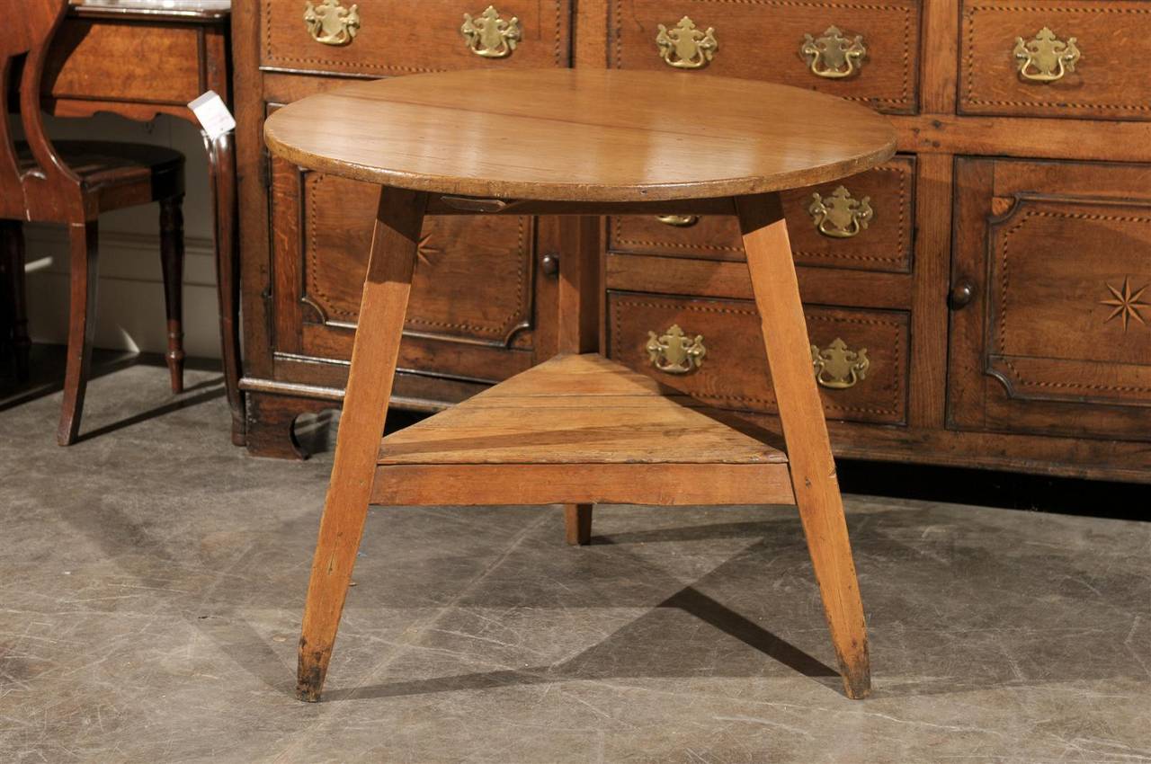 A three-legged English cricket table with shelf made of pine from the mid-19th century. Cricket tables are rumoured to be named after the game of cricket, both seeming to date back to the 16th century. The three legs are particularly important as