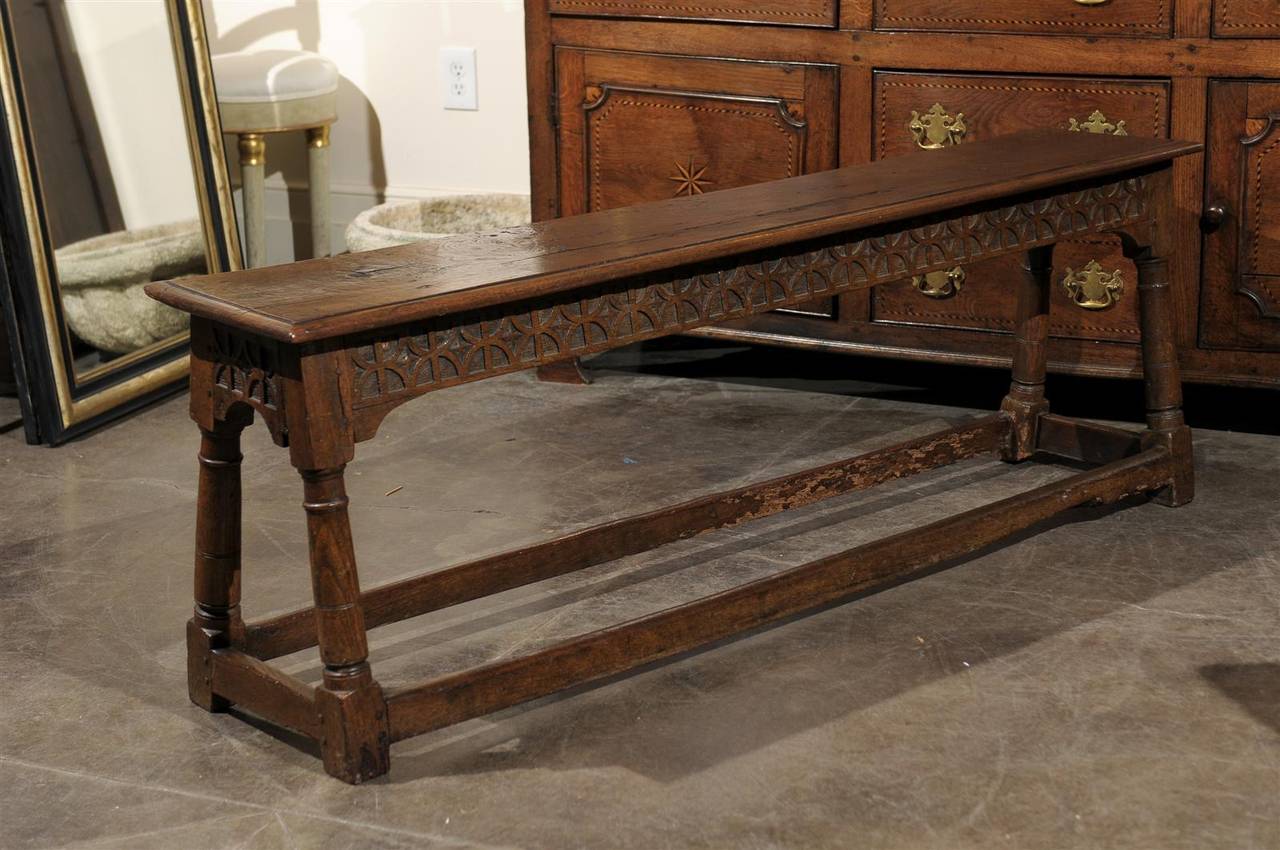 Early long English bench with stretcher.