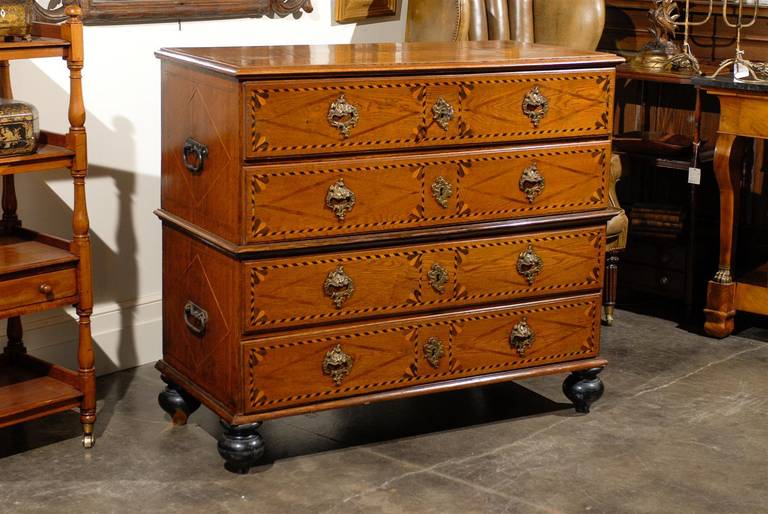 This splendid Italian four-drawer commode from the late 18th century is made in two parts with lateral handles for easy transport when travelling, which would have been common at the time. The rectangular top is visually separated into two