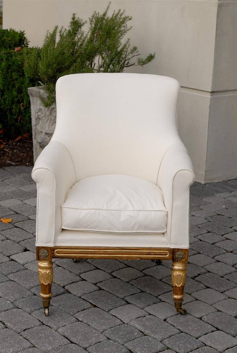 English Regency Upholstered Armchair with Painted and Gilt Wood Legs on Casters In Good Condition For Sale In Atlanta, GA