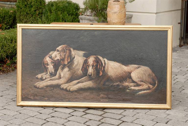 Large oil of reclining dogs in gilt wood frame. Signed Dorez.