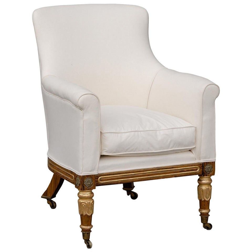 English Regency Upholstered Armchair with Painted and Gilt Wood Legs on Casters For Sale