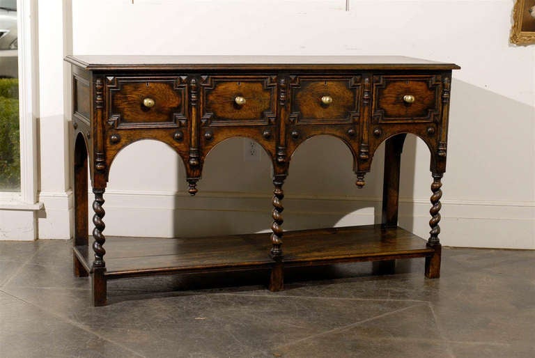 This exquisite English late 19th century server features a rectangular top with beveled edge over four geometric drawers with brass pulls. The graceful Renaissance inspiration is noticeable in the facade. The server is indeed supported by three
