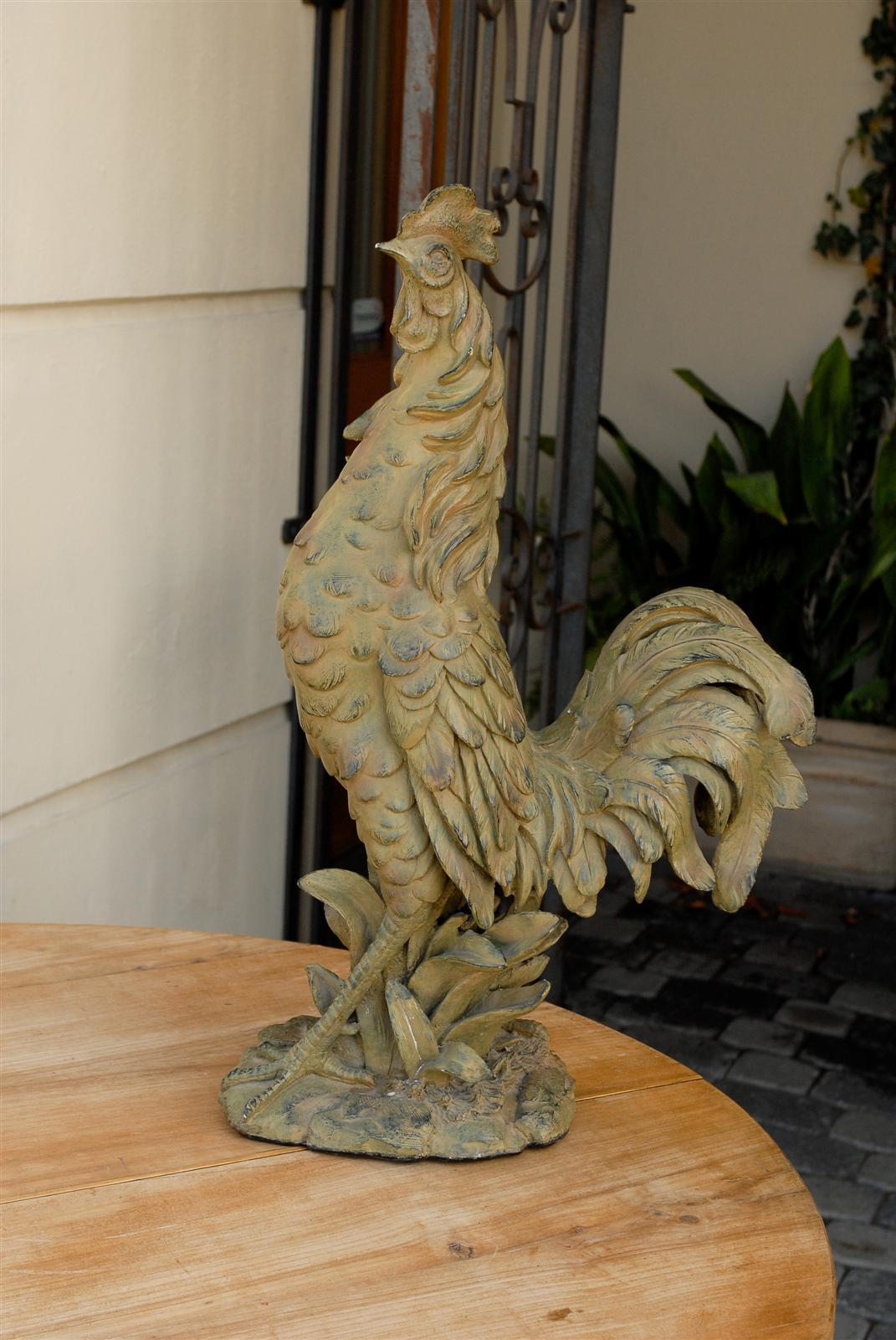 A French vintage rooster sculpture from the mid-20th century. We all know that eagles are the symbol for America. Roosters are the French national emblem. This particular one is made of light colored composition and stands tall as it surveys the