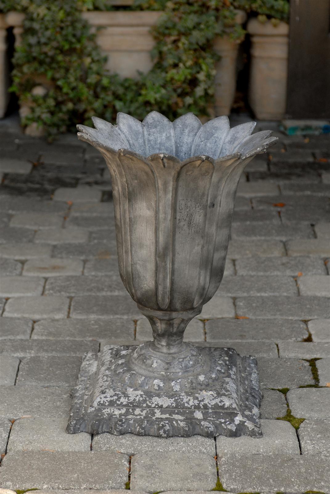 A French zinc planter from the early 20th century. This zinc planter resembles the shape of a flower with petals opening towards the sky, possibly like a cactus flower, which are common in Southern France. Narrowing at the base of the flower, the