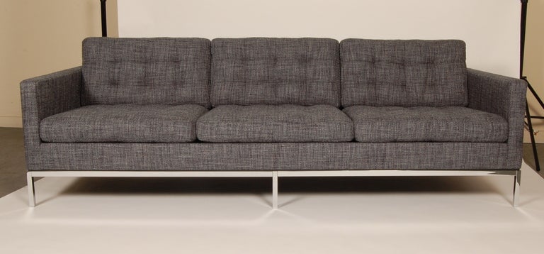 Newly revitalized sofa designed by Florence Knoll Bassett (1917- ), reupholstered in Knoll Fabric (Sonnet), along with the leg base being rechromed and polished. Retains original labeling, this is a vintage  early 1960s production piece.