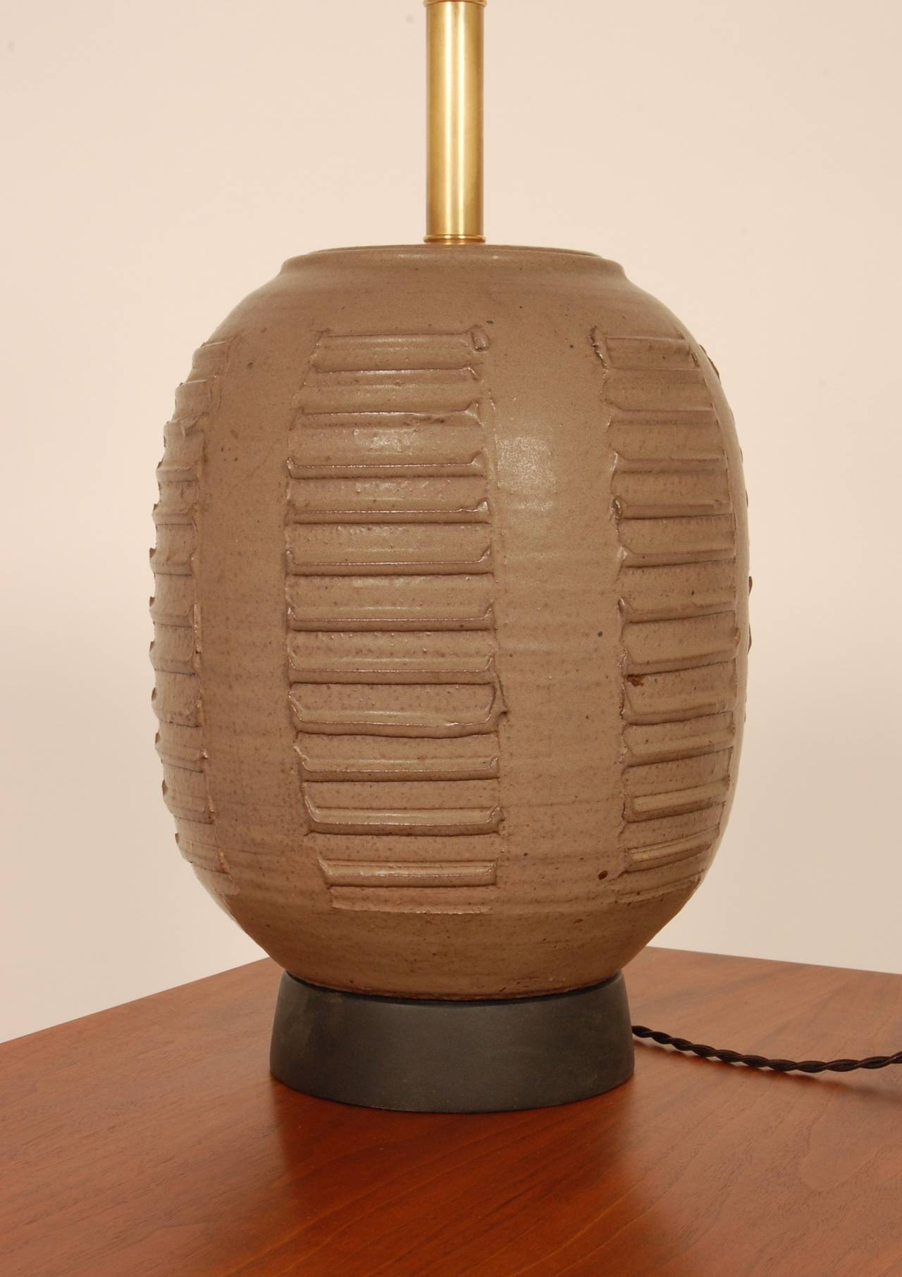 Hand thrown studio ceramic lamp by Bob Kinzie of California. Textured repeating patterns around the entire body of the lamp and has been newly rewired. The height measurement is from the base to the top of the socket.