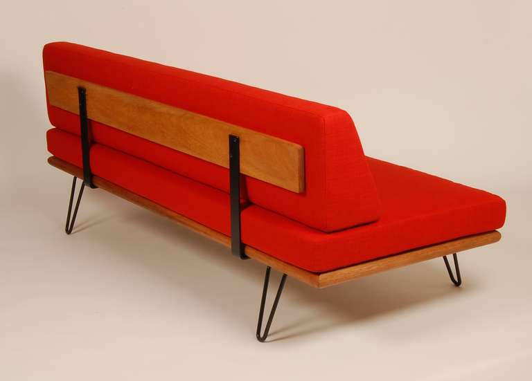 Vibrant orange-red day bed, thin profile and hair pin legs give the piece a light and airy presence. Total restoration with every aspect of the piece redone, new fabric, foam, new Pirelli webbing and the frame refinished. 1950s design and