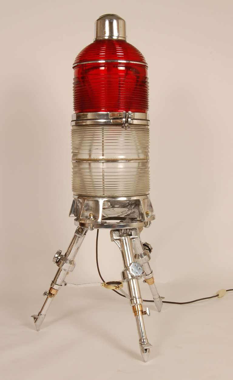 Vintage airport circa 1950's runway lamp that has been reassigned to the civilian sector. Red and white ribbed glass with both an upper and lower lamp for illumination. The housing is an industrial grade aluminum that has been machine polished and