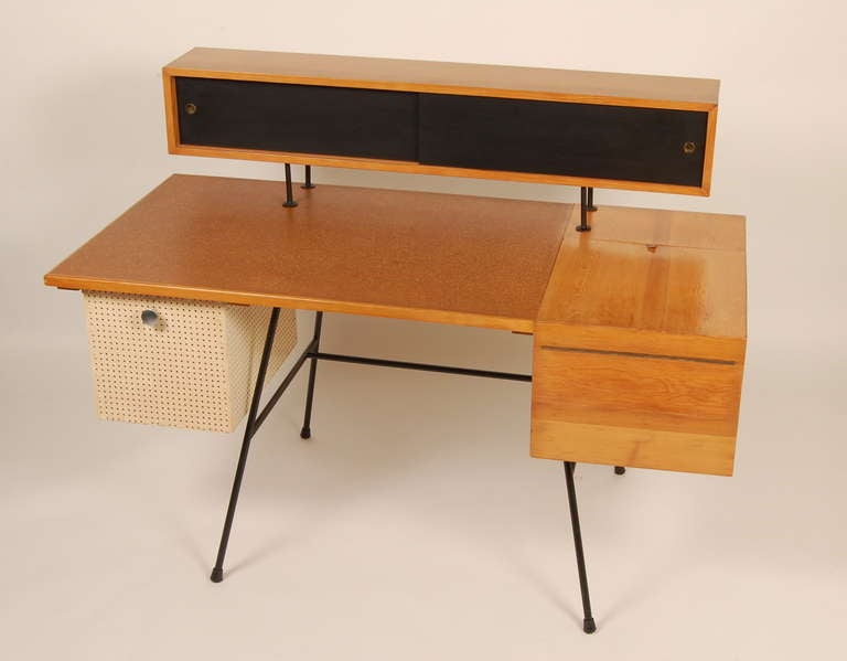 An interesting and fun reiteration of George Nelson's Home Office Desk design created by an unheralded craftsperson sometime during the 1950s. Having a number creative design features, i.e. cork top, floating storage compartment, flip-top cabinet