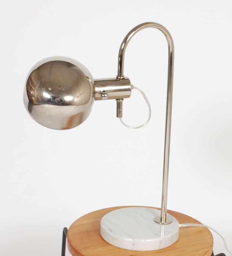 Modernist Italian table lamp, curved chromed stem with a marble base, the shade is also a chromed metal that pivots and turns for light adjustment.