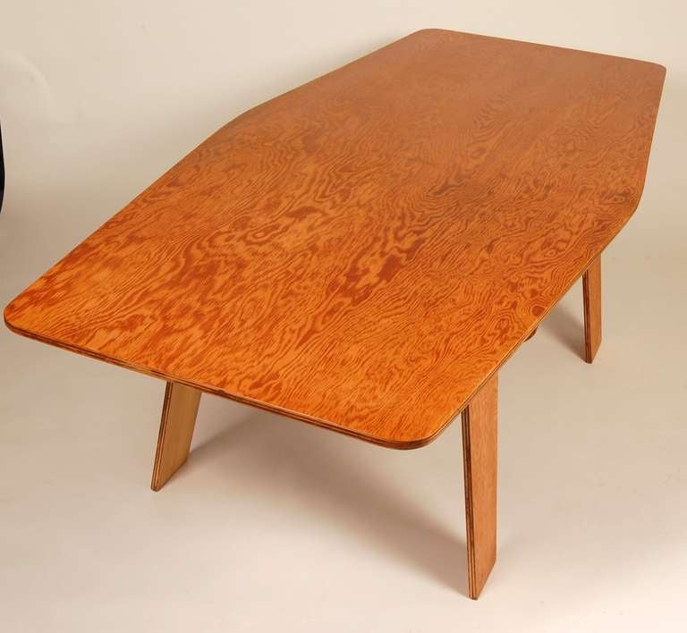 Knock down plywood table / desk consisting of five pieces which fit together via notch joinery with no glue or other fasteners and breaks down flat. It's dimensional apex is at it's center creating a soft diamond form. Designed and created by an