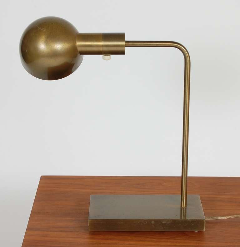 1970's era table lamp by Casella in a bronze finish. Rotating dome shade and with a dimmer switch.
