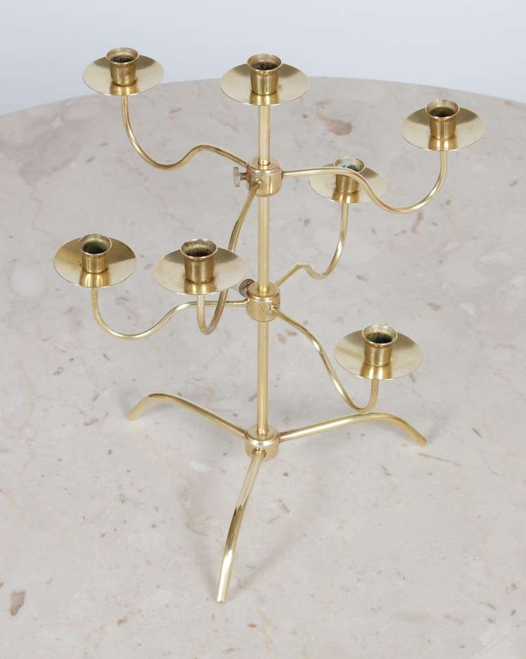 Delicate table top brass candelabra from Sweden. The two sets of arms are adjustable, stamped on the main stem.